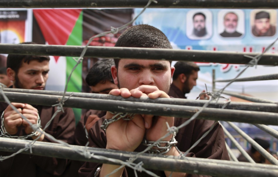 hamas supporter portrays plight palestinian prisoners behind bars rally jabalya along northern